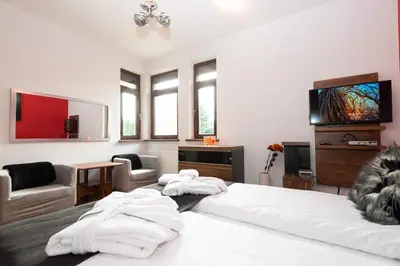a bedroom with a bed with towels on it at Charming place - Kraków Gdów Jacuzzi in Gdów