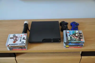 a table with two dvds and a laptop and controllers at Bridge Apartments 6 in Kraków
