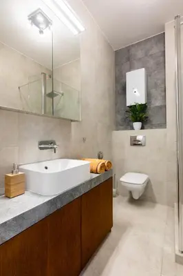 a bathroom with a white sink and a toilet at Bridge Apartments 6 in Kraków