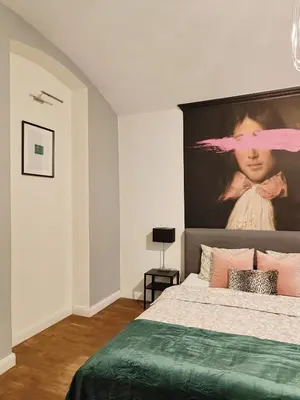 a bedroom with a large bed with a large headboard at A&K Apartment in Kraków