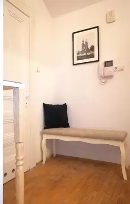 a bench in the corner of a room at A&K Apartment in Kraków