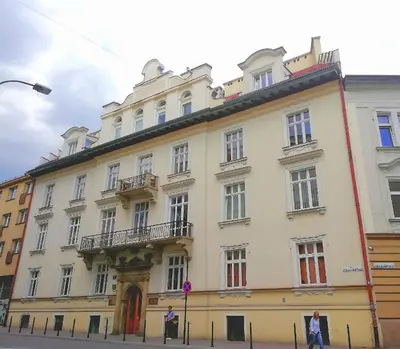 a large white building on the side of a street at A&K Apartment in Kraków