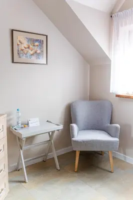 a chair and a desk in a room at Stanica Hucuł in Sułkowice