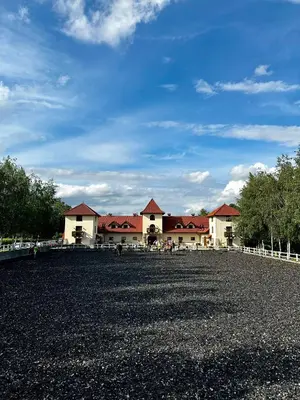 a large building with red roofs on a gravel field at Stanica Hucuł in Sułkowice