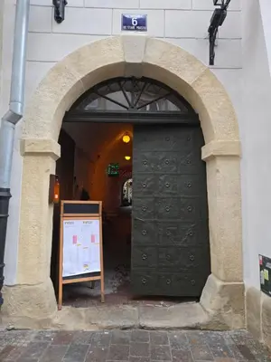 an archway with a black door in a building at Draggo House Rooms - Old Town in Kraków