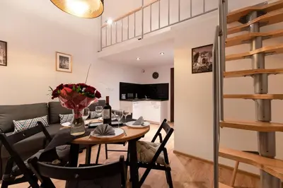 a dining room and living room with a table and chairs at DIETLA 99 APARTMENTS - IDEAL LOCATION - in the heart of Krakow in Kraków
