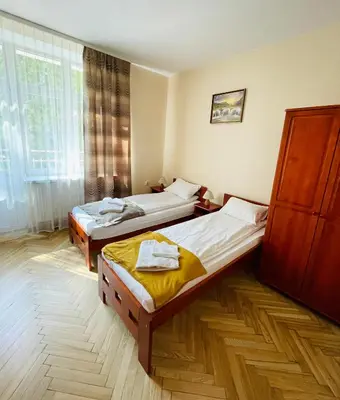 a balcony with a table and chairs on a building at Parkowa Rezydencja Hubal in Rabka