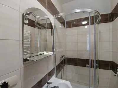 a bathroom with a shower and a sink at Parkowa Rezydencja Hubal in Rabka