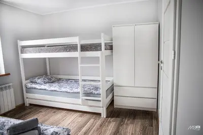 a room with two bunk beds and a closet at Domek u Mai in Zator