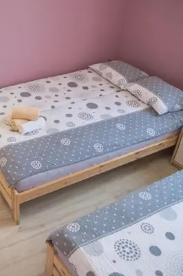two twin beds in a room with blue and white sheets at Domek u Mai in Zator