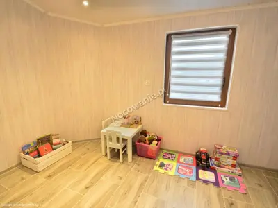 a corner of a room with a table and a window at Domek u Mai in Zator
