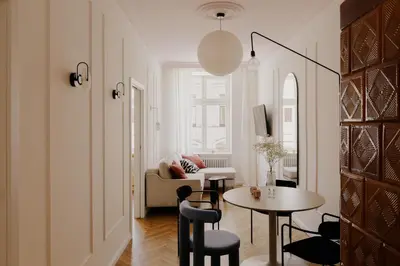 a living room with a table and a couch at Apartments Floriańska 24 by MB Apartments in Kraków