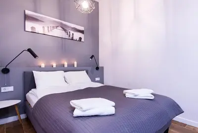 a bedroom with a bed with two white pillows on it at Apartments Floriańska 24 by MB Apartments in Kraków