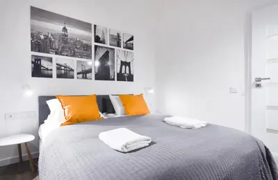a bedroom with a bed with two towels on it at Apartments Floriańska 24 by MB Apartments in Kraków