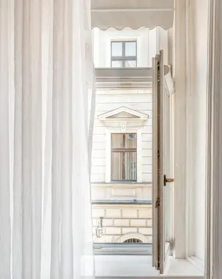 an open window with a view of a building at Apartments Floriańska 24 by MB Apartments in Kraków
