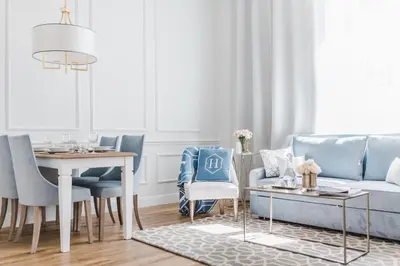a living room with a blue couch and a table at Apartament Golden Place in Kraków