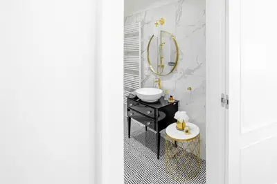 a bathroom with a sink and a mirror at Apartament Golden Place in Kraków