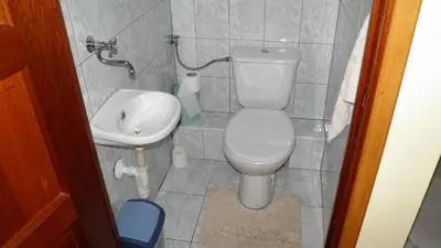 a small bathroom with a toilet and a sink at Podelniska in Porąbka