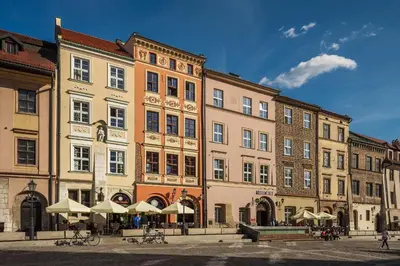 a large building with umbrellas in front of it at MR 3 Apartments in Kraków