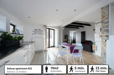 a kitchen and dining room with a table and chairs at Station Apartments Katowa 11 in Kraków