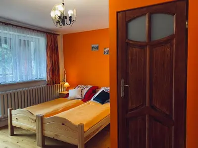 a bedroom with a bed and a door at Agroturystyka SKALNE in Szczawa