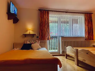 a bedroom with a bed and a window at Agroturystyka SKALNE in Szczawa