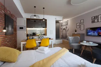 a living room with a bed and a dining room at Silver Apartment Old Jewish Quarter in Kraków