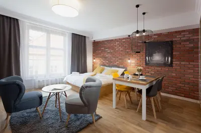 a bedroom with a bed and a table and chairs at Silver Apartment Old Jewish Quarter in Kraków
