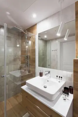 a bathroom with a white sink and a shower at Silver Apartment Old Jewish Quarter in Kraków