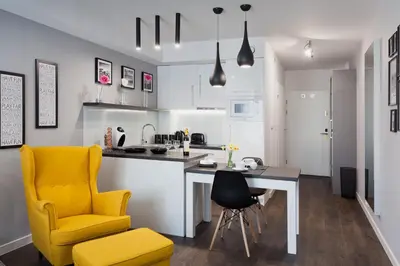 a kitchen with a desk and a yellow chair at City Point Apartment Old Jewish Quarter in Kraków