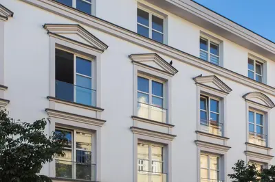 a white building with windows at City Point Apartment Old Jewish Quarter in Kraków