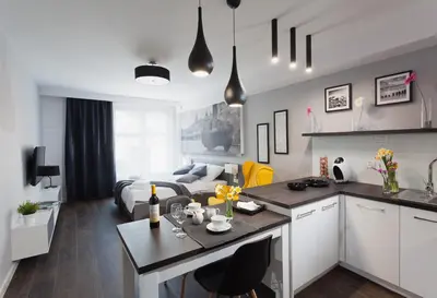 a kitchen and a living room with a couch at City Point Apartment Old Jewish Quarter in Kraków