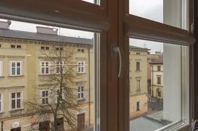 a window with a view of a building at Native Apartments Augustiańska 24 in Kraków