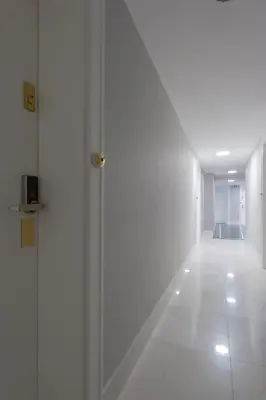 a hallway with a glass door in a building at Native Apartments Augustiańska 24 in Kraków