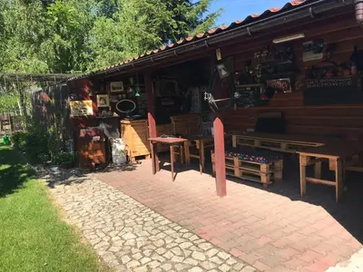 a log cabin with a table and chairs in front of it at Studio Roxi in Bachowice
