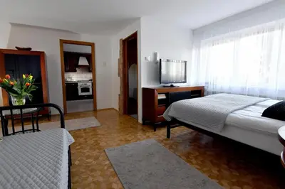 a hotel room with a bed and a television at Apartament Spytkowice - ENERGYLANDIA KRAKÓW OŚWIĘCIM WADOWICE in Spytkowice