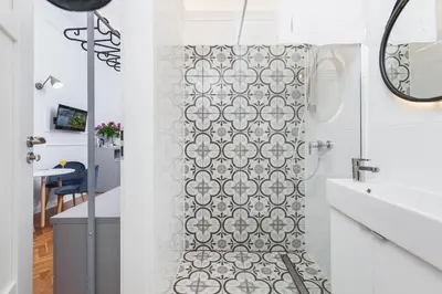 a bathroom with a shower curtain and a sink at The Old Town View in Kraków