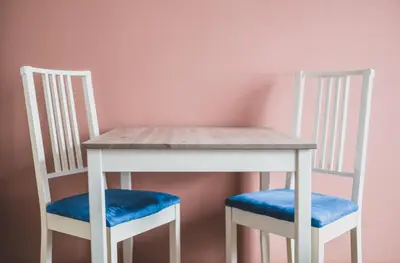 a white table and two chairs with a table at Cybulskiego Guest Rooms in Kraków