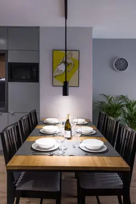 a dining room table with plates and wine glasses at Exclusive Apartment Solna 1 in Kraków