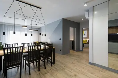 a dining room and living room with a table and chairs at Exclusive Apartment Solna 1 in Kraków