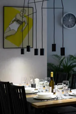 a dining table with glasses and a bottle of wine at Exclusive Apartment Solna 1 in Kraków