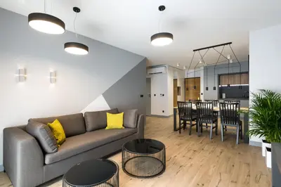 a living room and kitchen with a couch and a table at Exclusive Apartment Solna 1 in Kraków