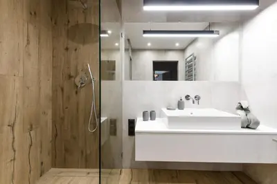 a bathroom with a white sink and a shower at Exclusive Apartment Solna 1 in Kraków