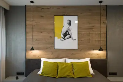 a bedroom with a bed with a picture on the wall at Exclusive Apartment Solna 1 in Kraków