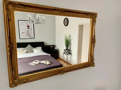 a mirror on a wall with a bed in a room at Dom Gościnny Krystyna - ENERGYLANDIA, SPYTKOWICE, ZATOR in Spytkowice