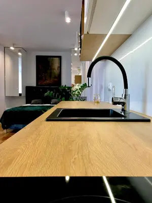 a kitchen with a sink and a living room at Dom Gościnny Krystyna - ENERGYLANDIA, SPYTKOWICE, ZATOR in Spytkowice