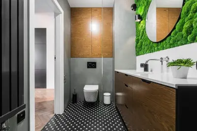 a bathroom with a sink and a toilet in a room at Moss Apartment in Kraków