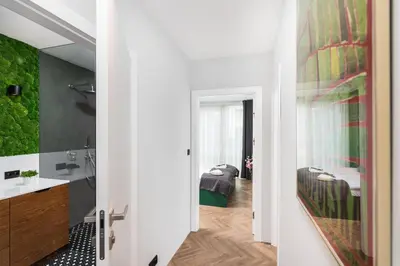 a bathroom with a sink and two beds at Moss Apartment in Kraków