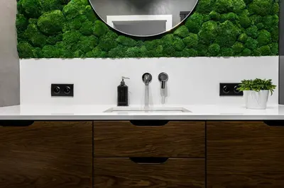 a bathroom with a white sink and a mirror at Moss Apartment in Kraków