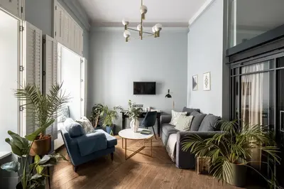 a living room with a couch and chairs and a table at Moja apartments in Kraków
